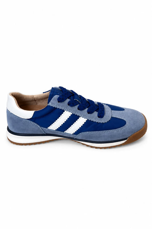 A blue suede low-top sneaker with white three-stripe detailing on the side, navy blue laces, and a brown gum sole, shown against a plain white background.